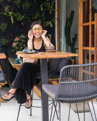Asian smile  girl  in a cafe. Beautiful Balinese women with a cup of coffee