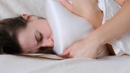 Depressed upset woman feeling sad lonely lying in bed alone trying to sleep thinking of problem, fears, worried and hopeless. Psychological therapy, lack of sleep