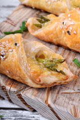 Green asparagus and cheese puff pastry folded as envelope and topped with sesame seeds