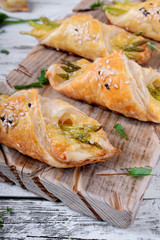 Green asparagus and cheese puff pastry folded as envelope and topped with sesame seeds