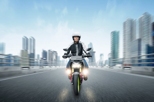 Rear View Of Asian Motorcycle Taxi Man Driving On The Asphalt Road