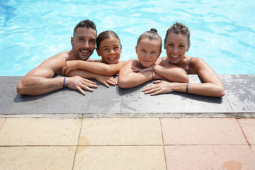 Family enjoying time at the swimming-pool