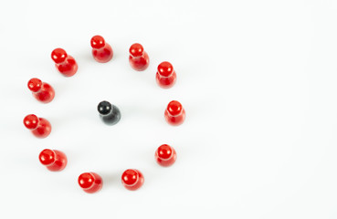 Many red meeple in a circle and one black meeple in the middle, white background, top view and copy space