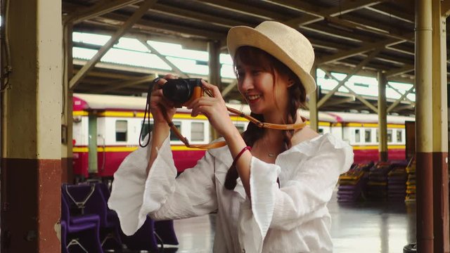 Asian women travel by train. Standing and taking pictures with a digital camera
