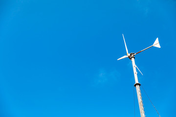 Wind turbines generating electricity with blue sky - energy conservation concept