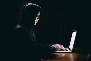 Hacker using laptop. Hacking the Internet