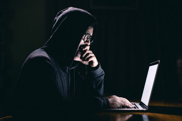 Hacker using laptop. Hacking the Internet