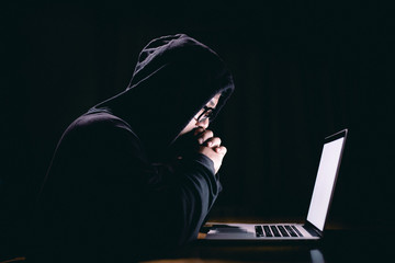 Hacker using laptop. Hacking the Internet