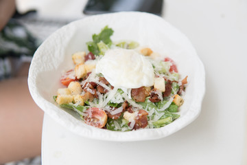 Cesar Salad with egg for breakfast in the restaurant.