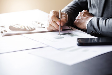Business man working at office with laptop and documents on his desk