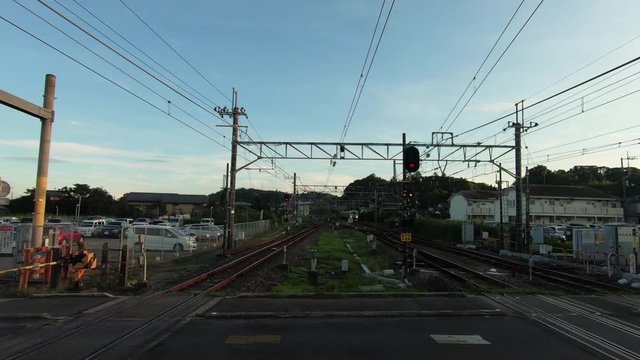 Railway approaching railroad crossing in the evening