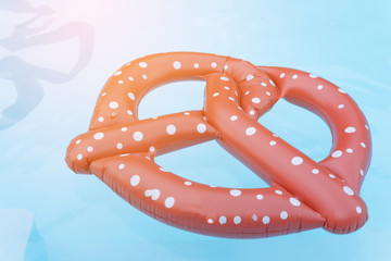 Pretzel Life buoy in a swimming pool, Summer vacation concept.