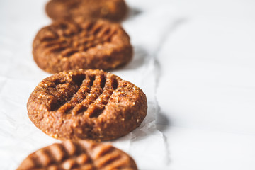 Vegan almond cookies from sweet potato or pumpkin on white background, close-up.