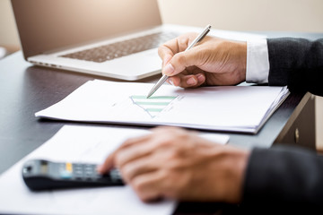 Business man working at office with laptop and documents on his desk