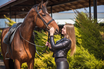 Obraz premium Hobby concept, woman with a horse on a horse farm. Human and animals friendship 