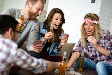 Group of friends relaxing and playing cards together. Young people hanging out together