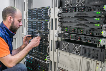 A technician installs a new hard disk into a powerful server. The system administrator replaces the...