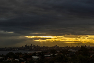 Sydney Panorama taken from a unique position at sunset, sunrays shining on the city