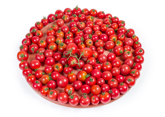 Cherry tomatoes on the wooden serving board on white background