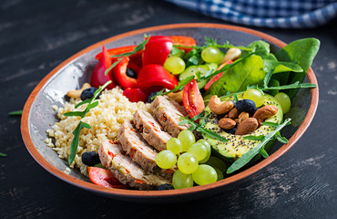 Buddha bowl dish with meatloaf, bulgur, avocado, sweet pepper, tomato, cucumber, berries and nuts. Detox and healthy superfoods bowl concept.