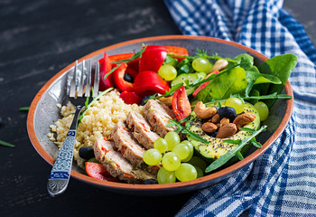 Buddha bowl dish with meatloaf, bulgur, avocado, sweet pepper, tomato, cucumber, berries and nuts. Detox and healthy superfoods bowl concept.