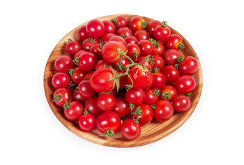 Cherry tomatoes on the wooden plate on a white background