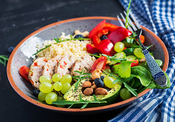 Buddha bowl dish with meatloaf, bulgur, avocado, sweet pepper, tomato, cucumber, berries and nuts. Detox and healthy superfoods bowl concept.