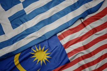 waving colorful flag of malaysia and national flag of greece.