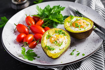 Avocado baked with egg and fresh salad. Vegetarian dish. Ketogenic diet. Keto food
