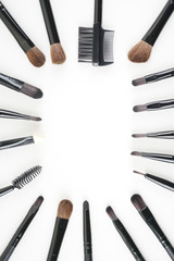 Make up brown brushes  and tools set up over white background. women make up concept. Flat lay, top view. Copy space.