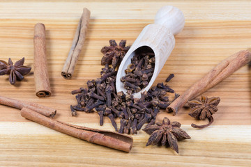Some dried spices on wooden surface close-up