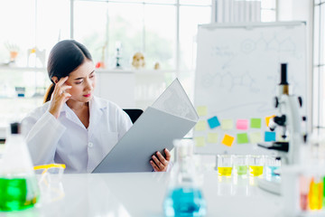 Positive delighted female scientist doing experiment