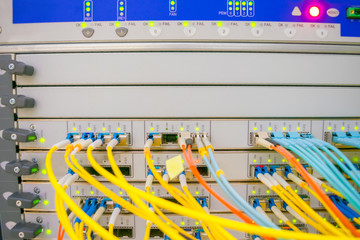 Front panel of the central router with a set of optical links is in the server room of the data...