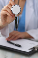 Doctor with a stethoscope in the hands, close up. Physician ready to examine and help patient. Medicine, healthcare and help concept