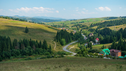 Naklejka premium Summer sunny day mountains, Beautiful landscape of a european mountain valley with village, sunny day in summer.