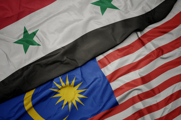 waving colorful flag of malaysia and national flag of syria.