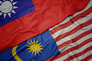 waving colorful flag of malaysia and national flag of taiwan.