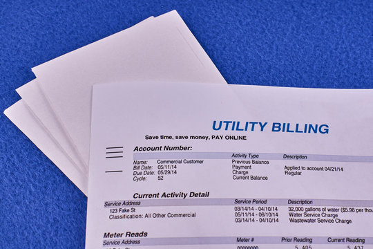 Utility billing sheet nad envelopes on a blue velvet background
