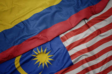 waving colorful flag of malaysia and national flag of colombia.
