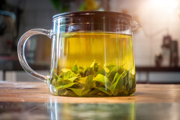 pot of verbena tea on old wooden table