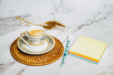 Tasse de café expresso bloc notes et stylo sur une table en marbre
