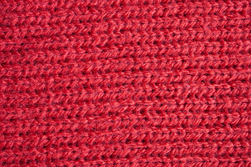 Red knitted wool fabric texture background