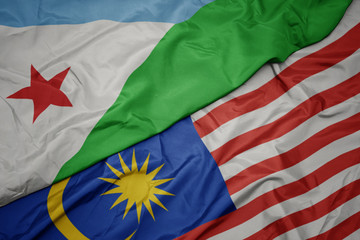 Fototapeta premium waving colorful flag of malaysia and national flag of djibouti.