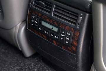 Fototapeta premium View to the interior of car with dashboard of rear multizone climate-control after cleaning before sale on parking
