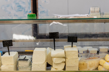 Cheese in a storefront on a streetmarket in Greece.