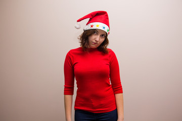 happy girl in santa hat in red blouse on white background 