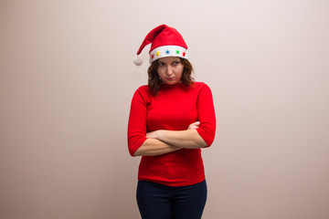 happy girl in santa hat in red blouse on white background 