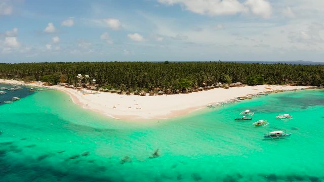 Tropical island with beautiful beach, palm trees and turquoise water view from above. Daco island, Philippines. Summer and travel vacation concept