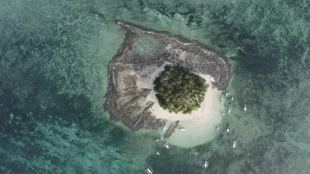 4K Aerial Drone Travel Footage Of Tropical Island With Palm Trees In the Philippines Guyam Siargao  Rotating over the Island with a birds eye view of the white  beach and blue sparkling water