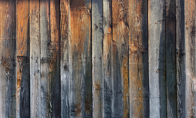 Beautiful texture of old dry rough dark wooden boards with mixed shades of gray and brown. Wood background Wallpaper.